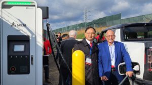 Delta's Automotive VP Charles Zhu and GM's Senior Manager New Battery Engineering Jim Khoury recharge a GMC HUMMER EV with the 400kW Extreme Fast Charger.