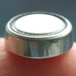 A button cell battery with a fuse