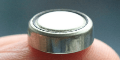 A button cell battery with a fuse