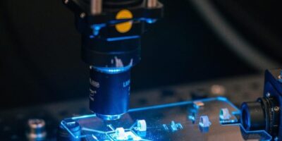 All glass femtosecond laser spinout for photonic quantum computing