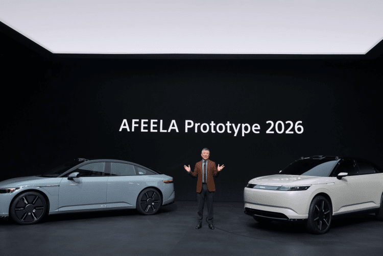 Presenter Yasuhide Mizuno on a CES-style stage between two Afeela vehicles, with “AFEELA Prototype 2026” displayed on the backdrop.